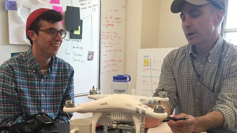 Jon, the client, showing Matt some features of the drone