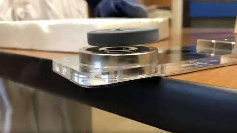 Video still of a superconductor levitating