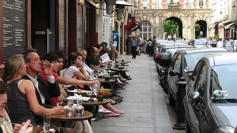 People dining on the street, outside of a Paris cafe