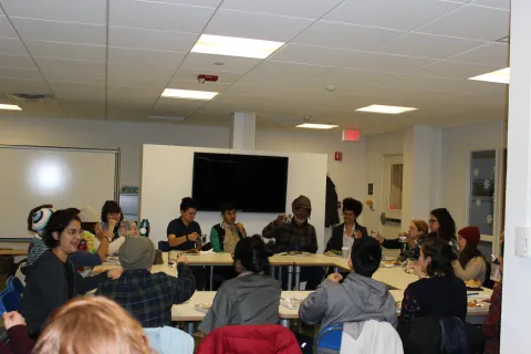 Picture of the event with Maurice Small and students around a table