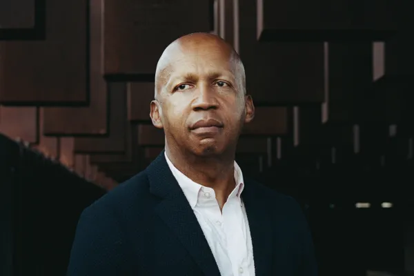 Bryan Stevenson in front of the National Memorial for Peace and Justice