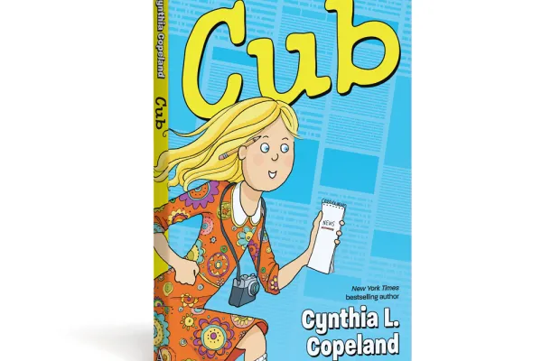cover of Cub graphic novel. Blonde kid in a orange paisley dress running with a camera and notebook