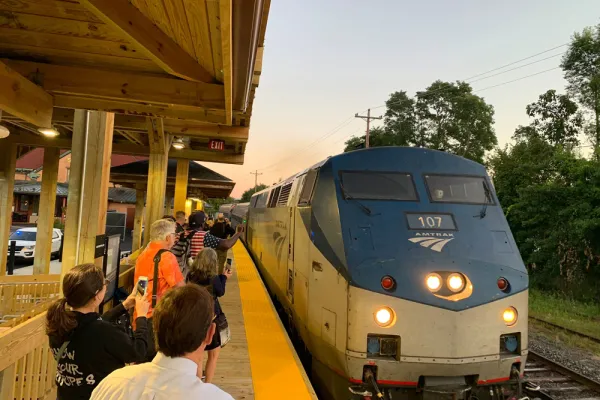 Amtrak train pulling into outdoor station