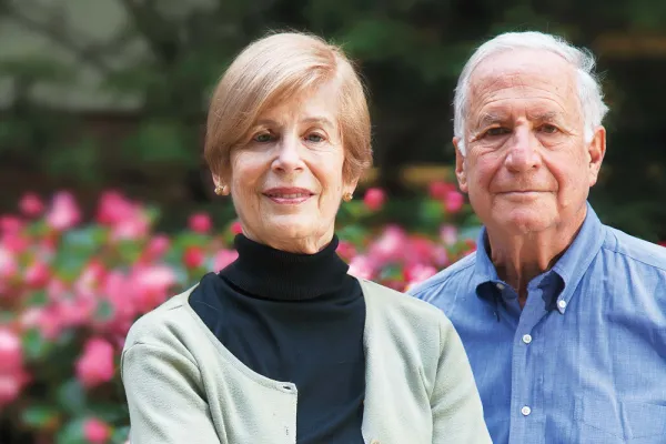 Helen and Dan Horowitz portrait in front of flowering bush