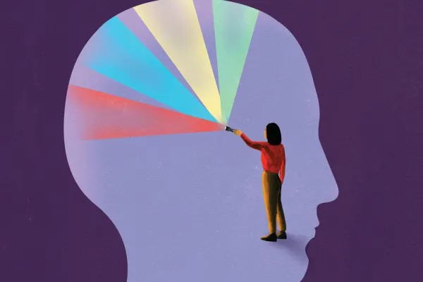 Illustration of a person inside an outline of a head, shining multi-colored light in all directions