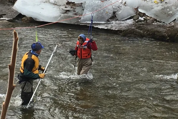 Fereshta Noori '18 surveying the Mill River with safety line help from Paul Wetzel, Smith lecturer in environmental science and policy.