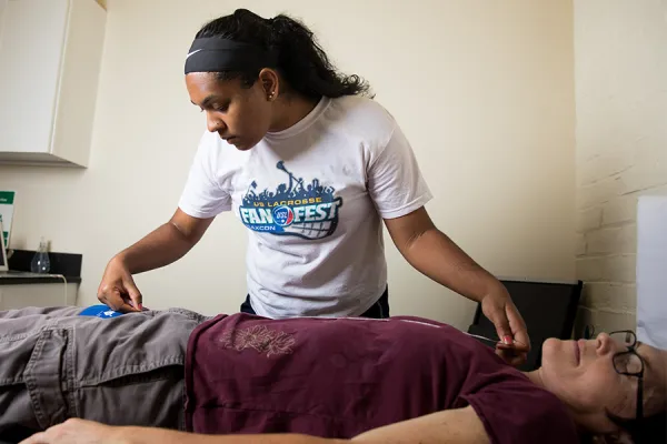 Abigail Edwards '20 demonstrates a pulse wave velocity test on her summer research adviser