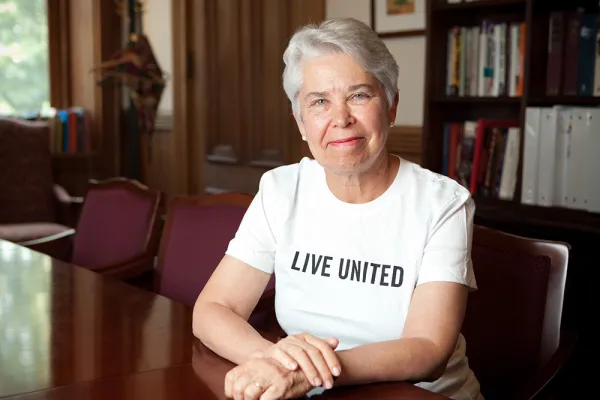 Carol Christ wearing a white t-shirt that says Live United