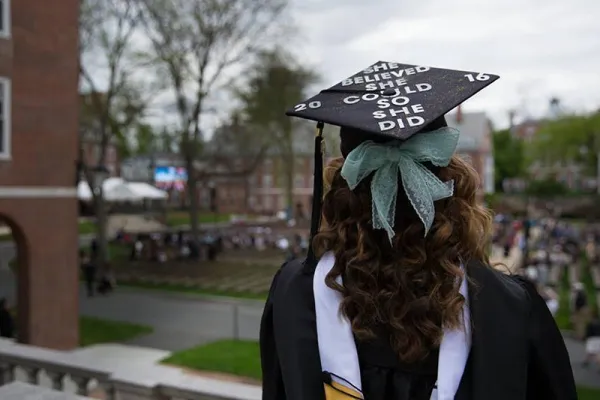 Student in commencement cap reading “She believed she could so she did”