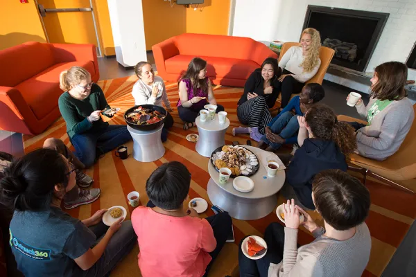 Group of students sitting in a circle having tea