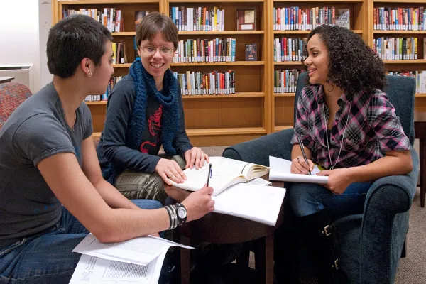Three students work together in Neilson Library