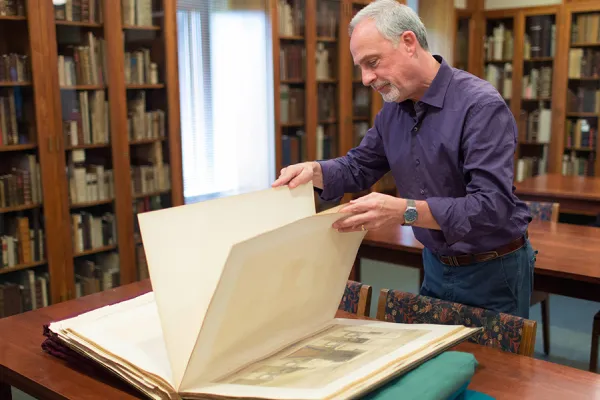 Martin Antonetti, curator of rare books at Smith, displays one of seven volumes of "The Holy Land," a rare set of volumes an alumna recently gave to the collection.