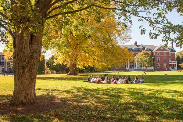 Group of students in a circle on the lawn in front of Chapin House