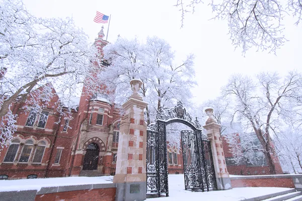 Winter shot of College Hall and the Grecourt Gates