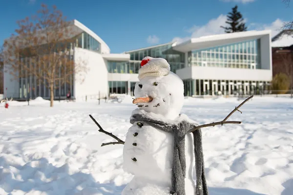 A snowman built in front of the campus center