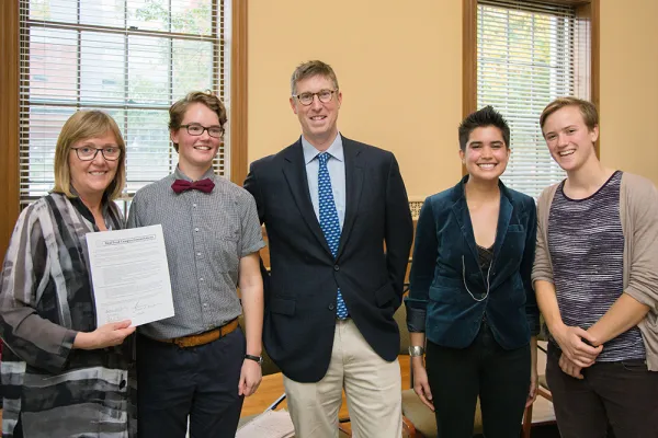 President Kathleen McCartney displays the college's Real Food Challenge commitment