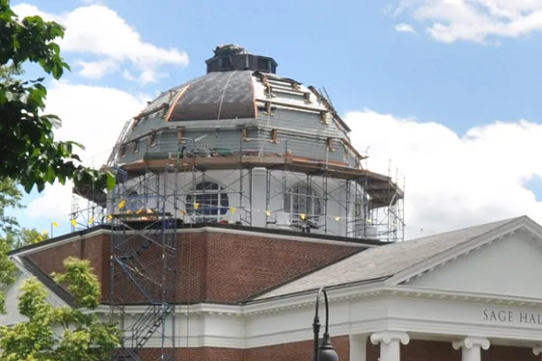 Construction crews and scaffolding on the Sage Hall dome