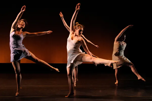 Four dancers in performance on stage
