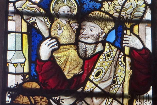 Crop of medieval stained glass showing a figure with a syphilitic nose