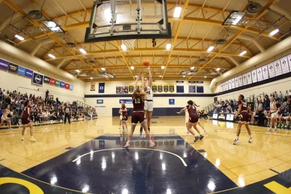 A Pioneer makes a shot during a basketball game