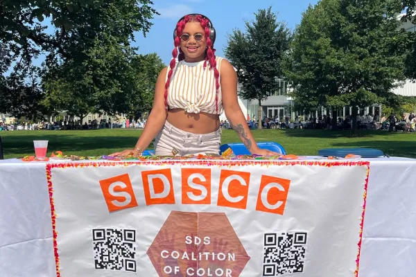 Aushanae Haller '23 holds a banner for the SDS Coalition of Color