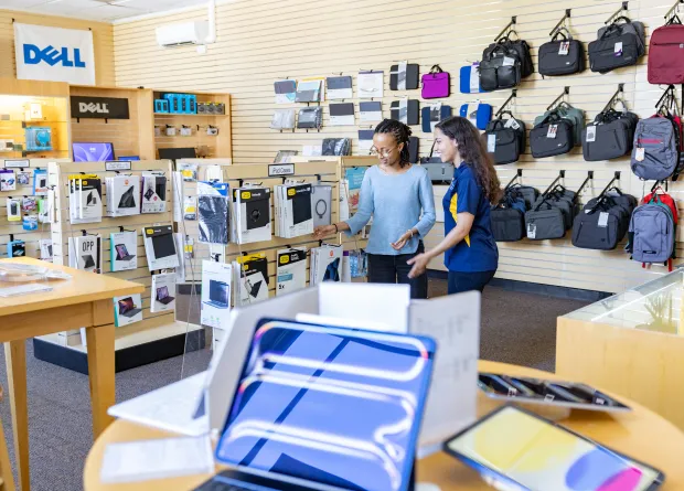 Two students peruse items in the campus computer store