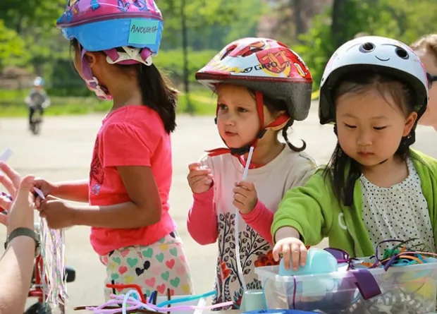 Three girls in bike helmets