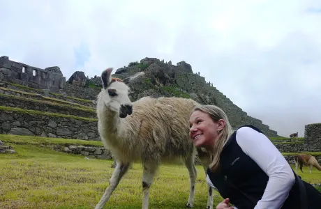 A woman poses with a llama
