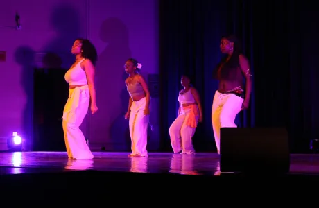 Students dancing in purple light