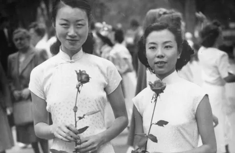 Two students holding roses on Ivy Day.