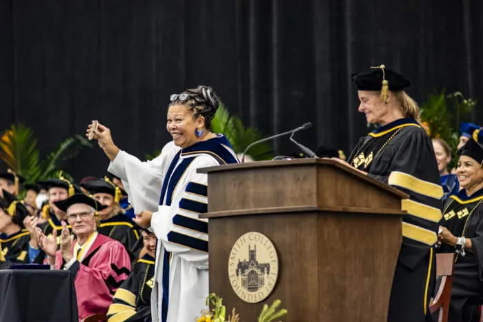 President Sarah Willie-LeBreton holding one of the symbols of office and showing it to the audience during the installation ceremony.