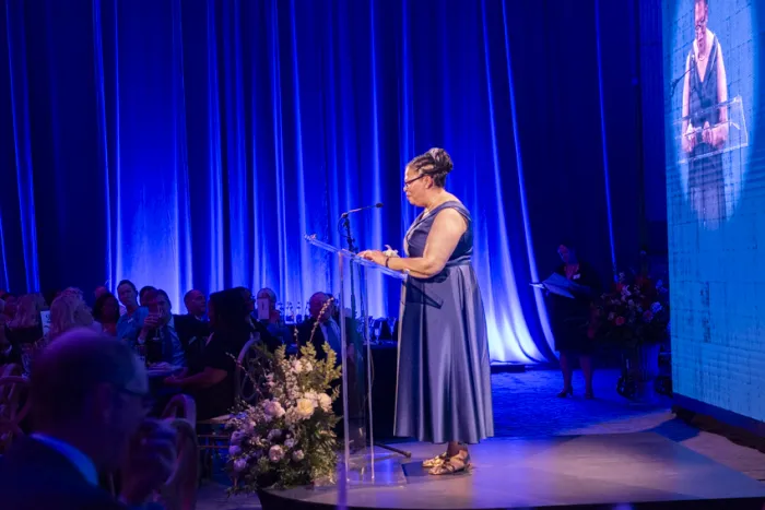 President Sarah Willie-LeBreton standing at a podium delivering remarks at the gala dinner.