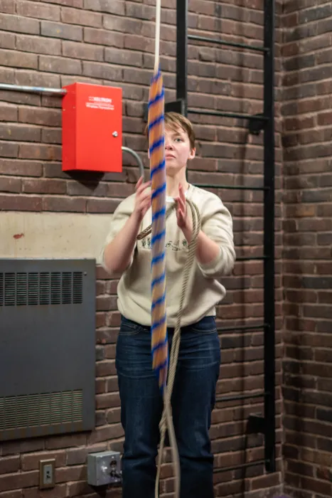 Maisy Hoffman ’25 rings a bell rope in Mendenhall Bell Tower