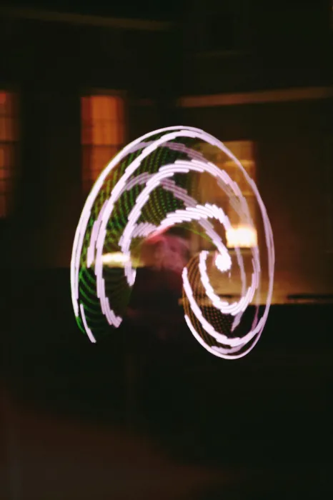 Una Fonte is a blur of swirling white color while dancing with LED hula hoops at night