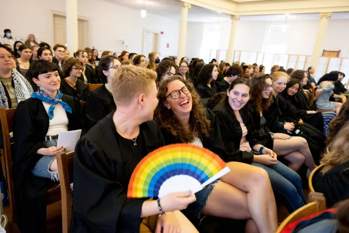 Students laugh in the chapel during Baccalaureate