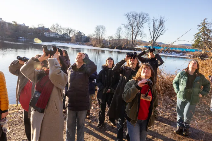 Students look up to see a bird during a recent bird walk.