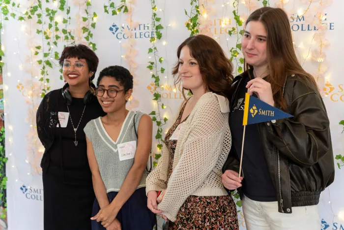 Students smile and pose in the photo booth