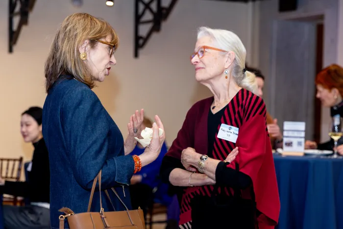 Two alums engaged in conversation.