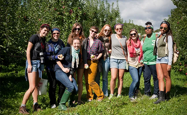 A group of Smithies smiling and posing together at an apple orchard.