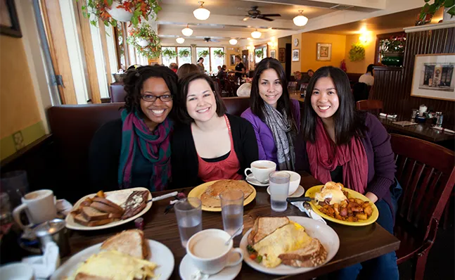 Four Smith students eating breakfast at Sylvester's restaurant in downtown Northampton.