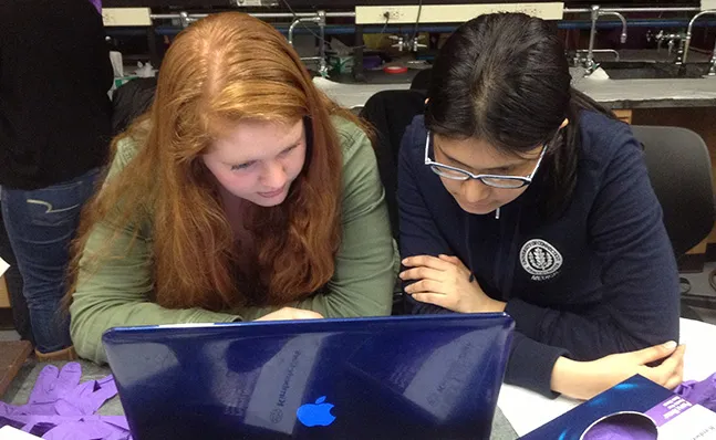 Two students reviewing data