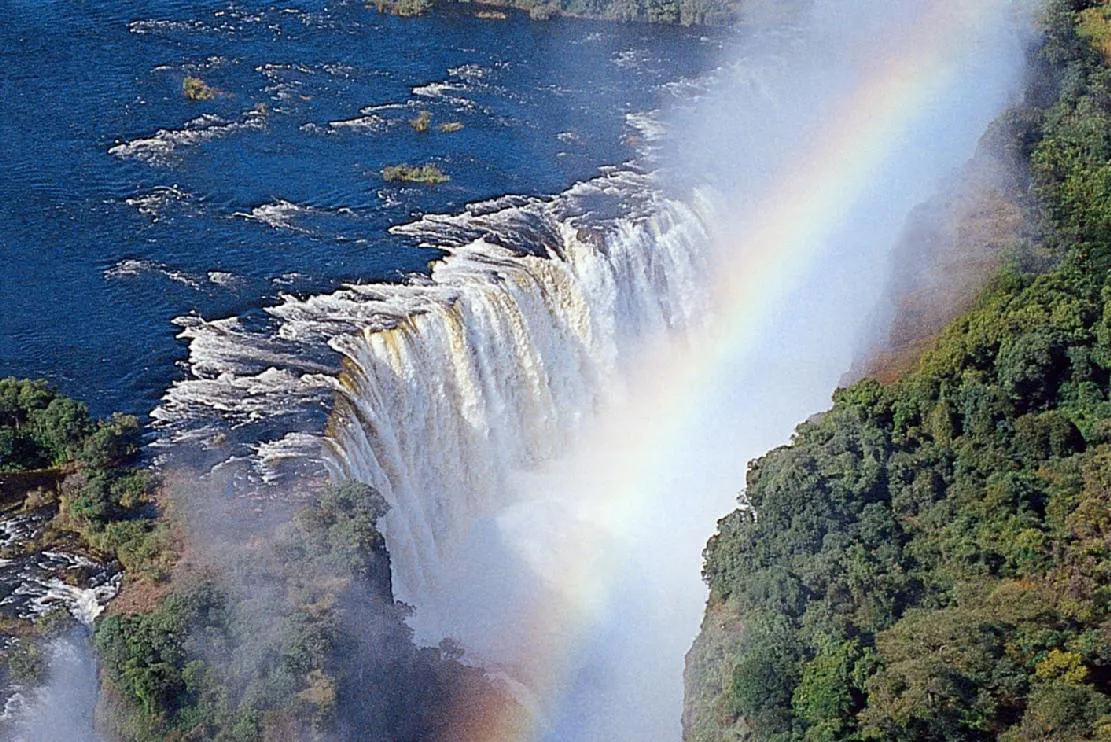 Victoria Falls in Zimbabwe, with a rainbow spanning the falls