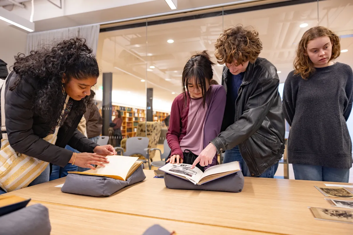 Students look at papers in Neilson Library on Cromwell Day.