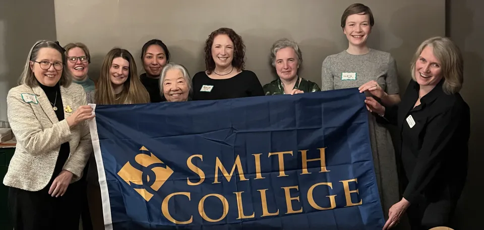 Alums gather with a Smith College banner in Dublin