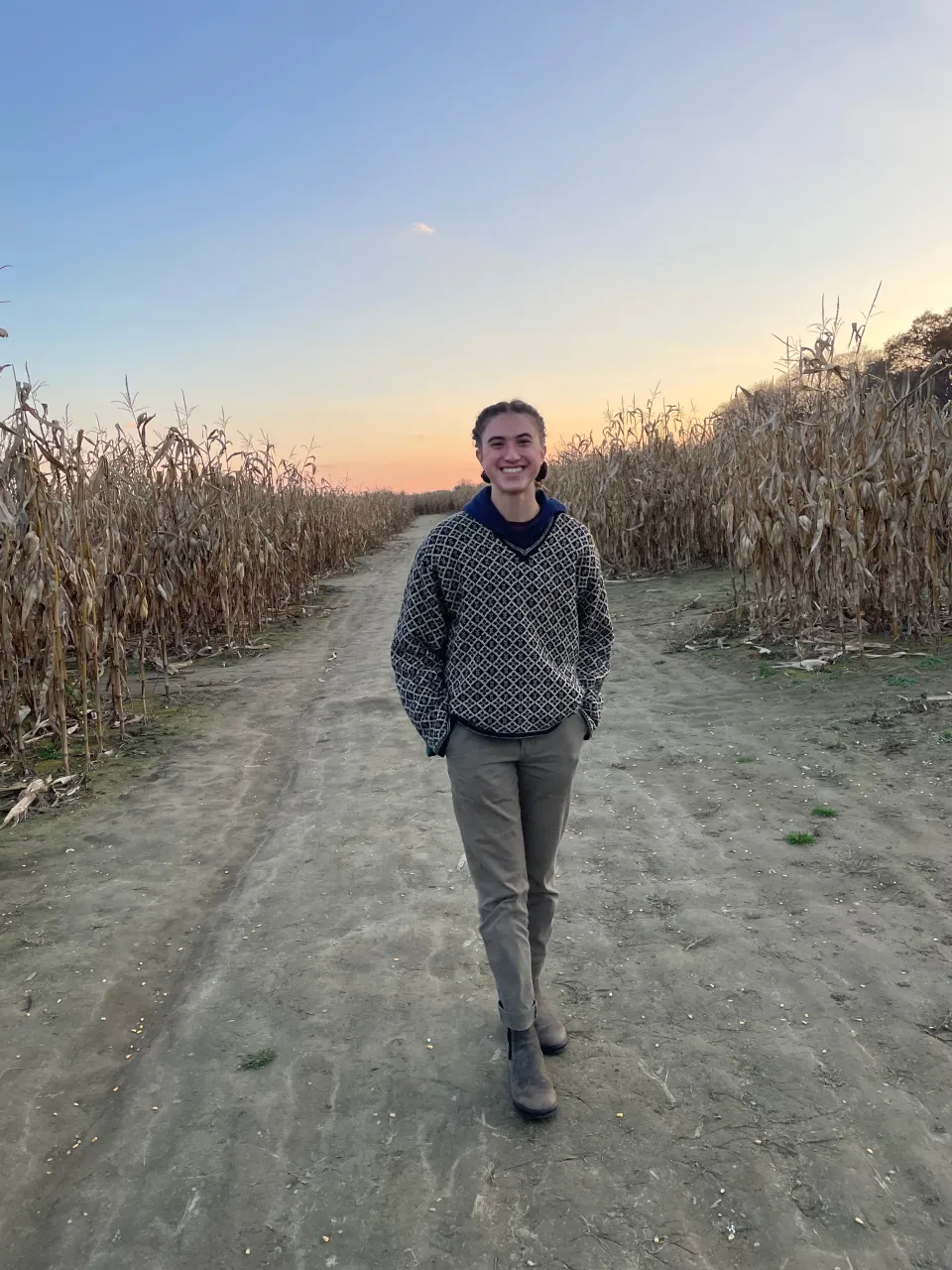 Pria Parker ’25 in a cornfield at sunset