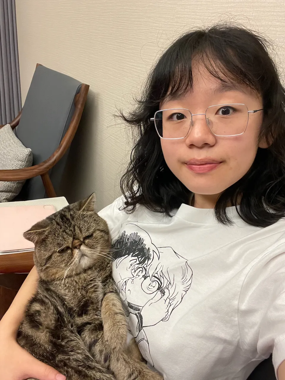 Sherry Li cuddles a cat in her lap