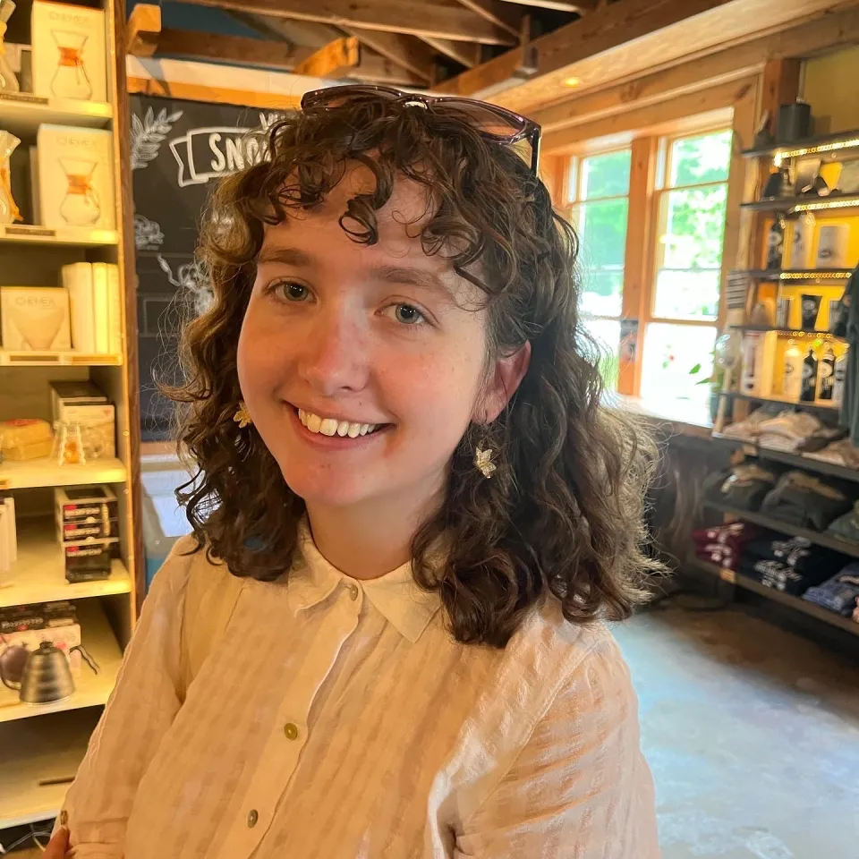 A profile photo of Claire Sullivan, smiling, in a store
