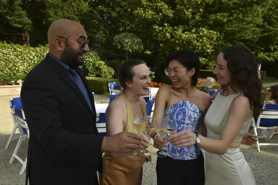 Four people laughing and talking outside in Paris
