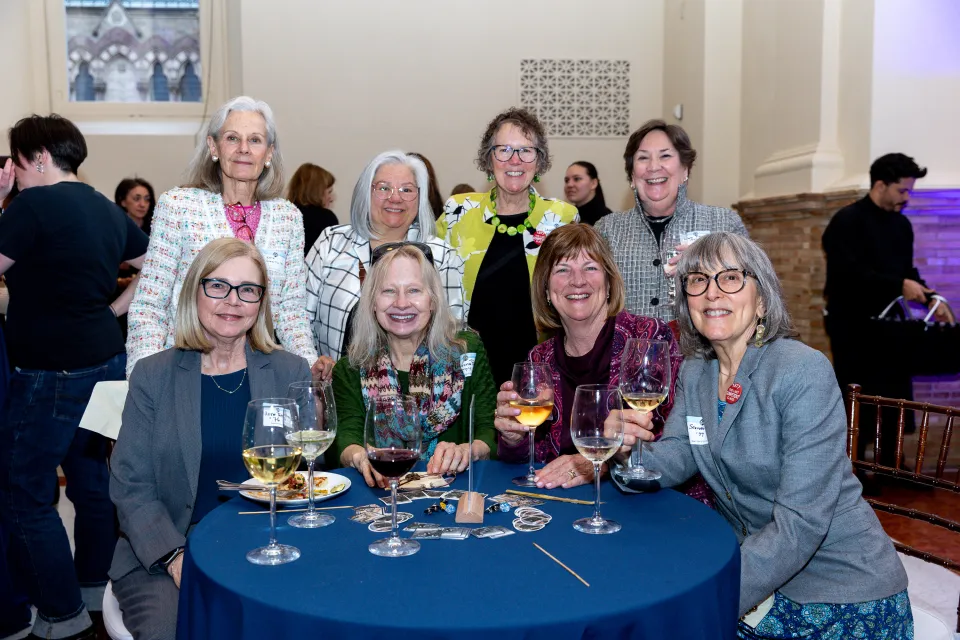 Members of the classes of 1976 and 1977 smile at the camera.