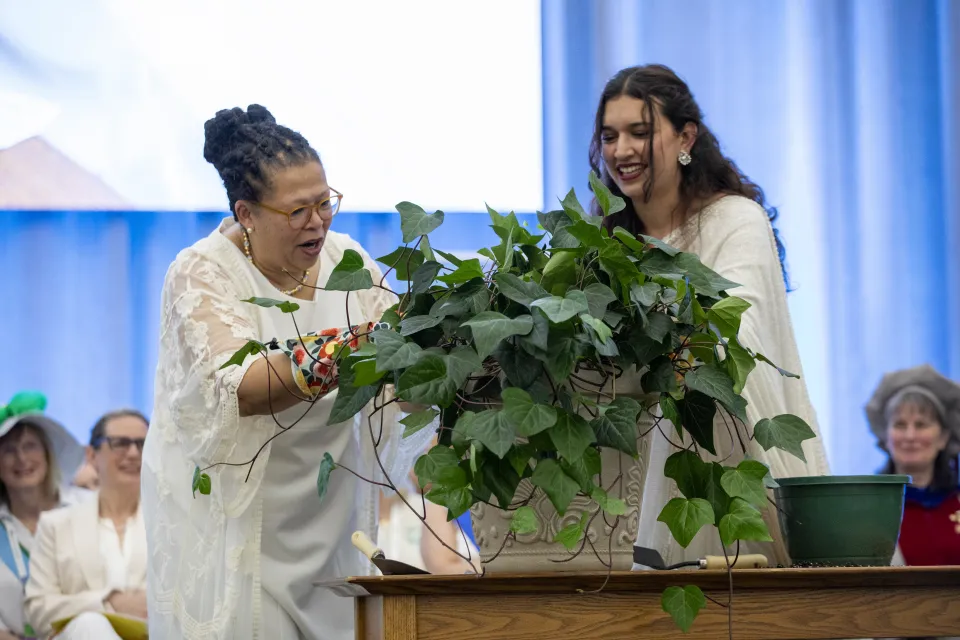 President Sarah Willie-LeBreton helps plant the ceremonial ivy during Ivy Day in 2025.
